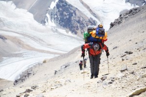 our-porter-facundo-carrying-our-clients-equipment-at-5850m